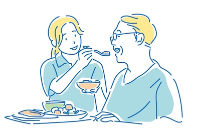 食事介助する介護職のイラスト